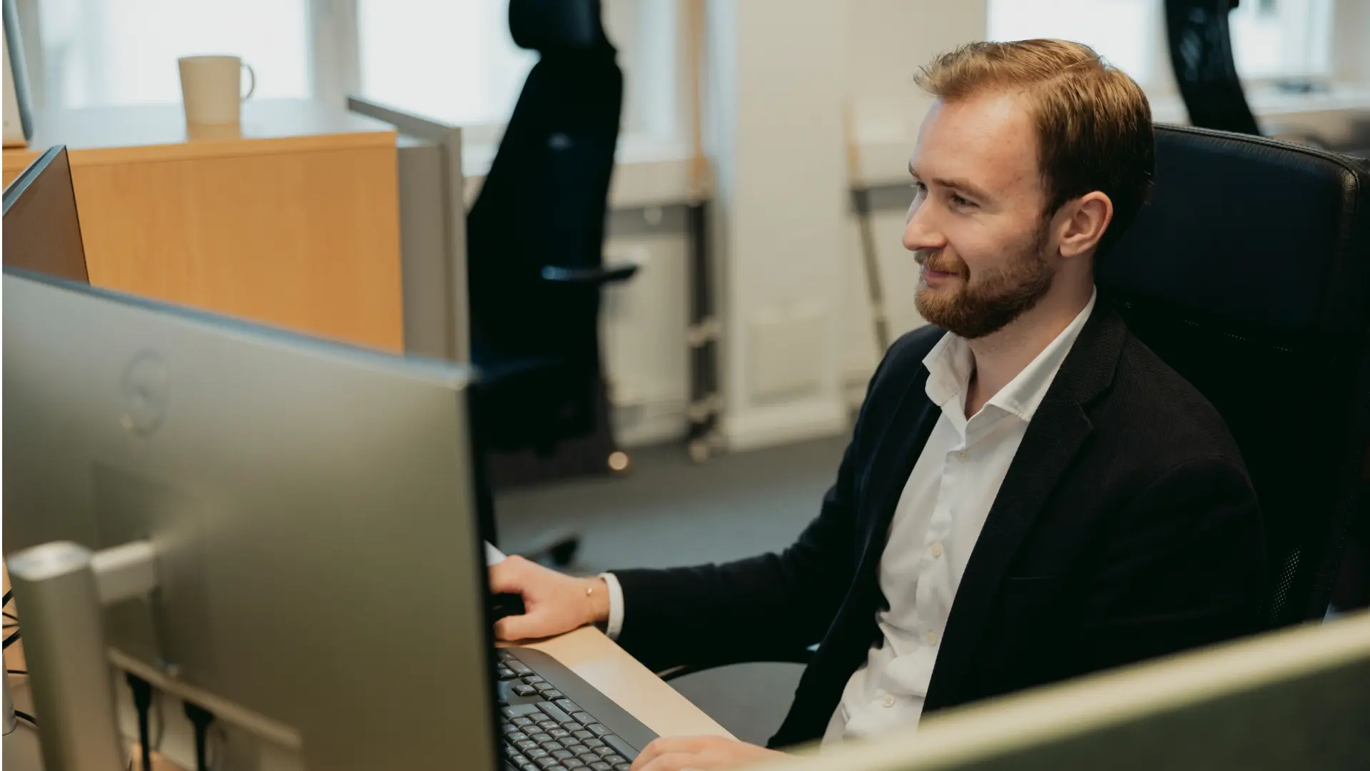 Person arbetar vid dator med NAB Ekonomi i Business Central för att hantera ekonomiska arbetsflöden.